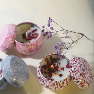 Scented soy wax candles in decorative metal tins with dried flower petals décor
