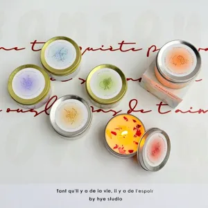 Handmade soy wax scented candles with dried flowers in travel tins