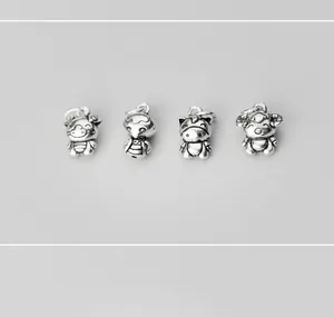 Close-up of four retro S925 sterling silver Chinese Zodiac charms for DIY bracelets
