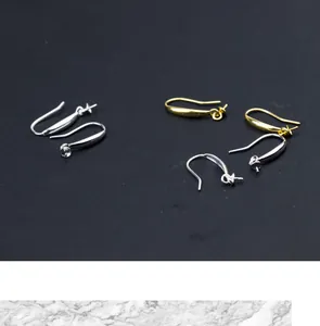 Macro view of S925 silver and gold-plated earring hook settings for DIY jewelry