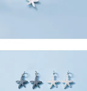 Vue détaillée de breloques en forme d'étoile de mer en argent S925 avec texture granulée