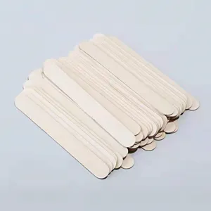 Macro view of stacked 125mm birch wood sticks for waxing, DIY crafts and ice cream