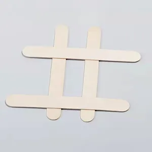 Detail shot of four 125mm natural birch wood popsicle sticks arranged in a cross