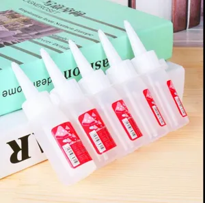 Detailed macro view of clear DIY craft glue bottles with precision tips for model making