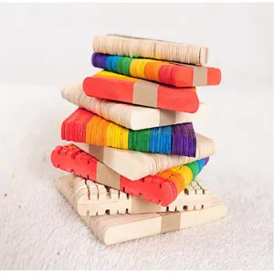 Detailed view of stacked colorful and natural wooden popsicle sticks for DIY craft projects