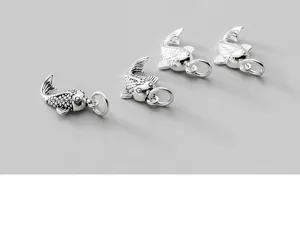 Detailed view of vintage S925 sterling silver koi fish charms for DIY jewelry making