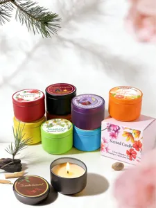 Variety of colorful scented candles in tins with floral lids and gift box packaging