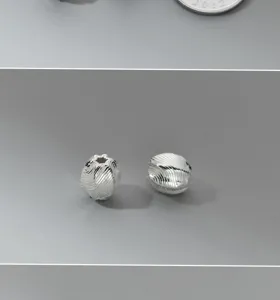 Close-up of vintage 925 sterling silver diagonal stripe olive spacer beads for DIY