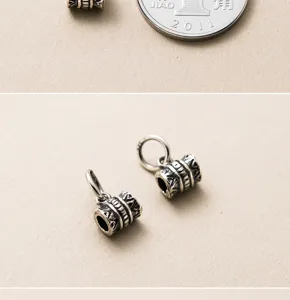 Detailed view of vintage S925 sterling silver tube charms featuring intricate engraved patterns