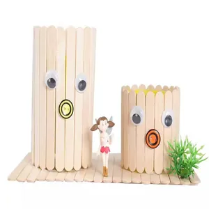 Close-up detail of a creative DIY ice cream stick pen holder with cute cartoon faces
