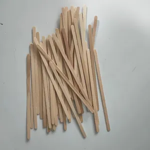 Detailed macro view of a pile of 140x5x1mm natural wooden coffee stir sticks.