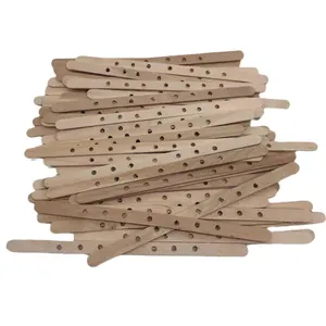 Wooden DIY craft sticks with multiple pre-drilled holes for handmade candle making projects.
