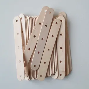 Close-up detail of pre-drilled wooden craft sticks, natural wood DIY multi-hole wooden bars.