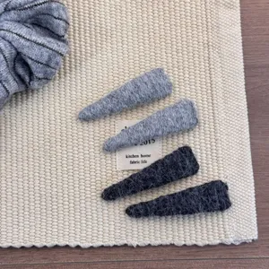Detailed view of soft wool fabric horn hair clips in stylish gray and charcoal shades
