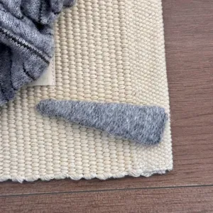 Macro view showing the soft gray woolen texture of a minimalist triangle hair clip.