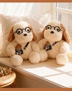Two cute plush puppy dolls wearing glasses and miniature cameras on a windowsill