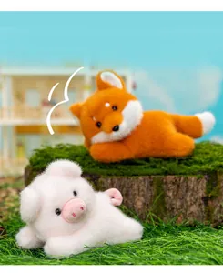 High-quality close-up of soft plush fox and pig toys resting on natural green grass