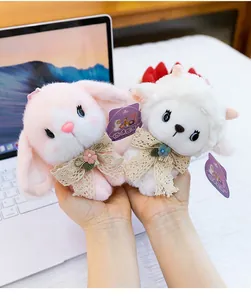 Detailed close-up showing cute plush bunny and sheep charms adorned with elegant lace bows