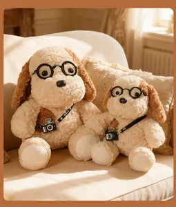 Detail view of two cute egg tart camera dog plush toys with round glasses accessories