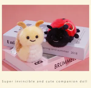 Close-up view of cute plush ladybug and bee insect keychains for bags and gift decoration