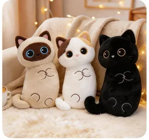 Detailed view of three cute plush cat pillows sitting on a soft white furry rug