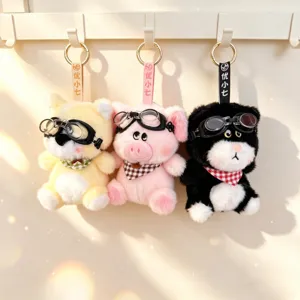 Detailed view of cute plush animal keychains with goggles and checkered scarves