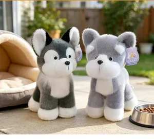 Close-up detail of two realistic plush puppy toys with soft grey and white faux fur textures