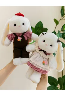 A charming pair of plush bunny couple dolls with cute outfits and carrot embroidery details.