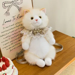 Detailed view of plush ragdoll cat backpack with lace collar on a table