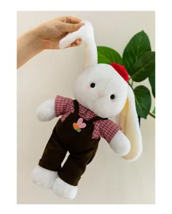 Close-up of a white long-eared plush rabbit doll wearing a red hat and plaid shirt
