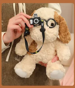 Close-up of cute plush egg tart puppy toy wearing glasses and holding a miniature camera.