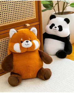 Close-up of cute chubby panda and red panda plush toys displayed in a cozy home setting