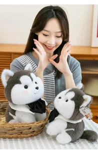 Close-up of two adorable husky plush toys with black bow ties in a lifestyle setting