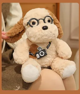Close-up detail of a cute beige plush dog wearing black glasses and a small toy camera