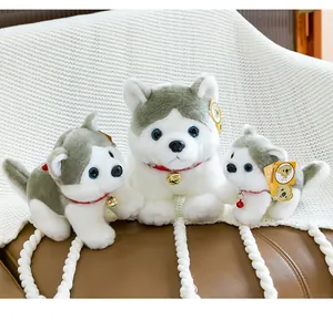 Tres adorables peluches de husky con collares rojos y cascabeles en una manta suave