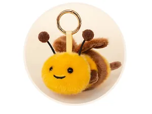 Detailed view of cute plush bee keychain with soft yellow and brown fuzzy texture