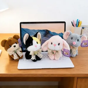 Set of four cute plush animal keychains featuring bear cat bunny and mouse on a laptop