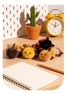 Macro view of cute plush insect keychains on a desk with cactus and yellow clock