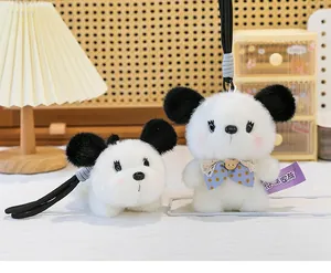 Detail view of two cute panda-style plush dog keychains with soft faux fur texture
