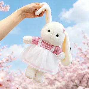 Adorable long-eared plush bunny doll in a pink checkered dress with cherry blossoms