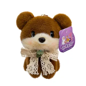 Adorable brown plush teddy bear keychain featuring a delicate lace bow and decorative leaf charm