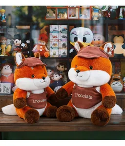 Cute pair of Maillard style plush fox toys sitting on a wooden shelf in a toy store.
