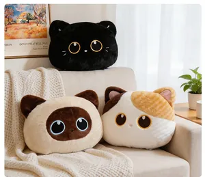 Group of three cute cat-shaped plush pillows arranged on a cozy home sofa setting