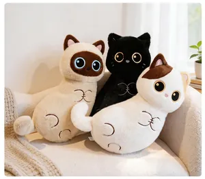 Detailed view of three adorable cat plush pillows with soft fur on a white cozy sofa