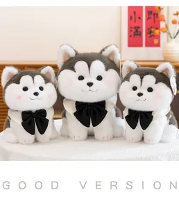 Three adorable husky plush toys with black bow ties sitting on a white lace tablecloth
