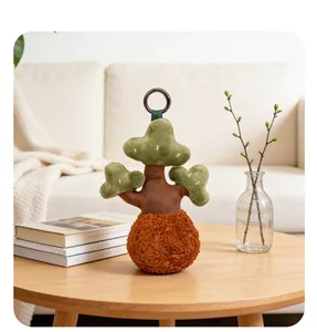 Creative plush pine tree keychain ornament on a wooden table in a cozy home setting