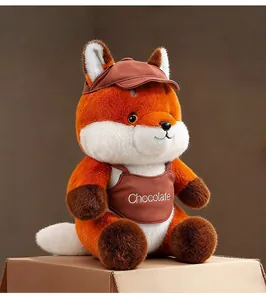 Detailed shot of a cute orange fox plush toy wearing a brown cap and Chocolate apron