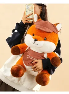 Adult model holding a large plush fox toy with a brown hat and 'Chocolate' apron detail.