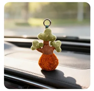 Creative plush tree pendant keychain displayed on a car dashboard under sunlight