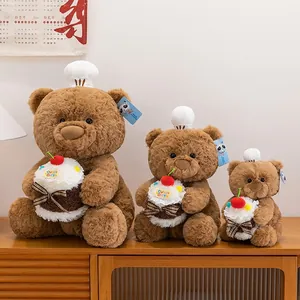 Set di tre orsetti di peluche marroni con cappelli da chef e cupcake per regali.